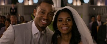 Movie still from “Think Like a Man Too” (2014), directed by Tim Story – A man and a woman smile for a picture; Close Up shot, Over the shoulder angle