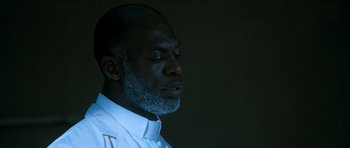 Movie still from “Thirst” (2009), directed by Park Chan-wook – A man with a gray beard is looking down; Close Up shot, Low angle