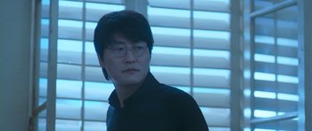 Movie still from “Thirst” (2009), directed by Park Chan-wook – A man in a black shirt is looking at the camera; Close Up shot, Low angle