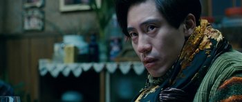 Movie still from “Thirst” (2009), directed by Park Chan-wook – A person wearing a suit and tie; Close Up shot, Low angle