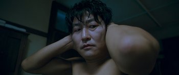 Movie still from “Thirst” (2009), directed by Park Chan-wook – A person with his hands behind his head; Close Up shot, Low angle