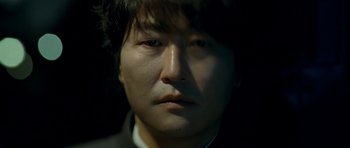 Movie still from “Thirst” (2009), directed by Park Chan-wook – A man's face in the dark; Extreme Close Up shot, Low angle