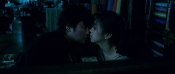 Movie still from “Thirst” (2009), directed by Park Chan-wook – A man and a woman kissing each other in a dark room; Close Up shot, Low angle
