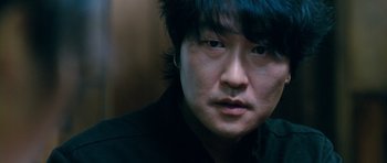 Movie still from “Thirst” (2009), directed by Park Chan-wook – A person wearing a black shirt; Close Up shot, Low angle