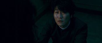 Movie still from “Thirst” (2009), directed by Park Chan-wook – A man in a black shirt and a white collar; Close Up shot, High angle
