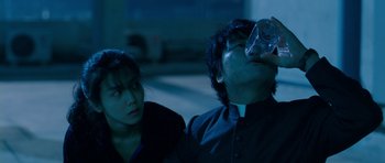 Movie still from “Thirst” (2009), directed by Park Chan-wook – A man and a woman sitting next to each other; Medium shot, Low angle