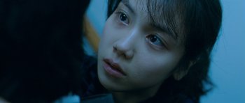 Movie still from “Thirst” (2009), directed by Park Chan-wook – A young woman's face; Close Up shot, Over the shoulder angle