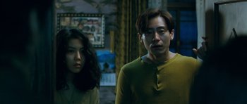 Movie still from “Thirst” (2009), directed by Park Chan-wook – A man and a woman standing next to each other in a room; Medium shot, Low angle