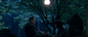 Movie still from “Thirst” (2009), directed by Park Chan-wook – Two men sitting on a bench in a park at night; Medium shot, Over the shoulder angle