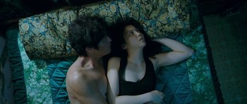 Movie still from “Thirst” (2009), directed by Park Chan-wook – A man and a woman laying in bed together; Medium shot, Overhead angle