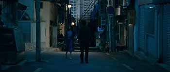 Movie still from “Thirst” (2009), directed by Park Chan-wook – A man and a woman walking down a street at night; Wide shot, Over the shoulder angle