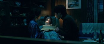 Movie still from “Thirst” (2009), directed by Park Chan-wook – A man and a woman holding a cake with candles on it; Medium shot, High angle