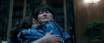 Movie still from “Thirst” (2009), directed by Park Chan-wook – A woman hugging another woman in front of a building; Close Up shot, Low angle
