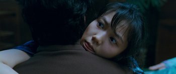 Movie still from “Thirst” (2009), directed by Park Chan-wook – A young girl laying down with a black cat; Close Up shot, Over the shoulder angle