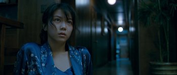Movie still from “Thirst” (2009), directed by Park Chan-wook – A woman in a blue robe standing next to a wall; Close Up shot, Over the shoulder angle