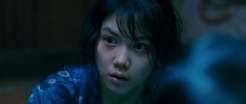 Movie still from “Thirst” (2009), directed by Park Chan-wook – A young woman with blue eyes stares into the camera; Close Up shot, High angle