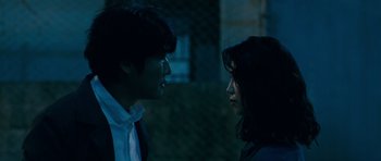 Movie still from “Thirst” (2009), directed by Park Chan-wook – A man and a woman standing next to each other in the dark; Close Up shot, Over the shoulder angle