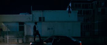 Movie still from “Thirst” (2009), directed by Park Chan-wook – A man walking on the side of the road at night; Extreme Wide shot, Low angle