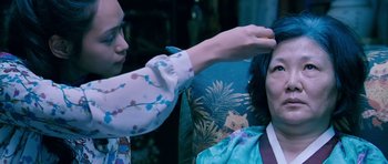 Movie still from “Thirst” (2009), directed by Park Chan-wook – A woman is getting her hair cut by another woman; Close Up shot, High angle