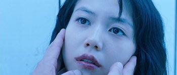 Movie still from “Thirst” (2009), directed by Park Chan-wook – A person with their hands on their face; Extreme Close Up shot, Low angle