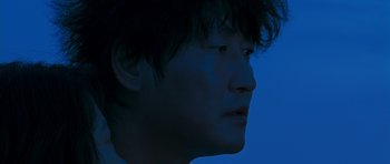 Movie still from “Thirst” (2009), directed by Park Chan-wook – A person's face in the dark; Close Up shot, Low angle