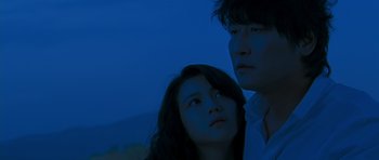 Movie still from “Thirst” (2009), directed by Park Chan-wook – A man and a woman standing next to each other; Close Up shot, Low angle