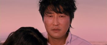 Movie still from “Thirst” (2009), directed by Park Chan-wook – A person wearing a white shirt; Close Up shot, Over the shoulder angle