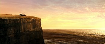Movie still from “Thirst” (2009), directed by Park Chan-wook – A large cliff overlooking a body of water at sunset; Extreme Wide shot, Low angle