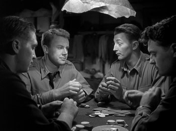 Movie still from “Thirty Seconds Over Tokyo” (1944), directed by Mervyn LeRoy – A group of men sitting around a table playing cards; Medium shot, Over the shoulder angle