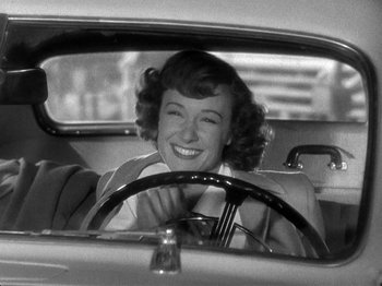 Movie still from “Thirty Seconds Over Tokyo” (1944), directed by Mervyn LeRoy – A black and white photo of a woman driving a car; Close Up shot, Low angle