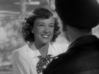 Movie still from “Thirty Seconds Over Tokyo” (1944), directed by Mervyn LeRoy – An old photo of a woman smiling at a man; Close Up shot, Over the shoulder angle