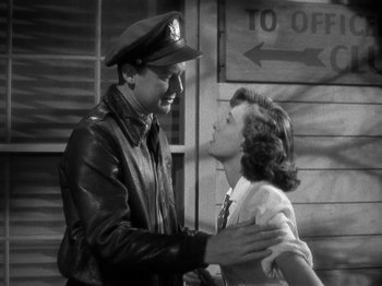 Movie still from “Thirty Seconds Over Tokyo” (1944), directed by Mervyn LeRoy – A man and a woman in a black and white photo; Medium shot, Low angle