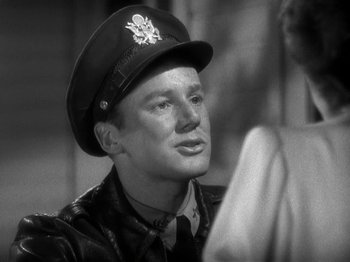 Movie still from “Thirty Seconds Over Tokyo” (1944), directed by Mervyn LeRoy – A man wearing a hat and a leather jacket; Close Up shot, Over the shoulder angle