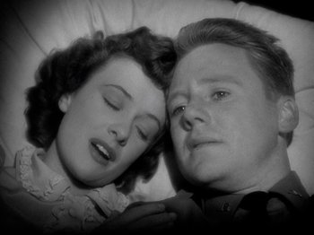 Movie still from “Thirty Seconds Over Tokyo” (1944), directed by Mervyn LeRoy – An older woman and a younger man laying in a bed together; Close Up shot, Overhead angle