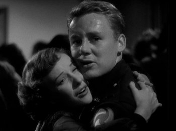 Movie still from “Thirty Seconds Over Tokyo” (1944), directed by Mervyn LeRoy – A man and a woman embracing each other; Close Up shot, Low angle