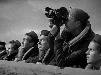 Movie still from “Thirty Seconds Over Tokyo” (1944), directed by Mervyn LeRoy – Black and white photograph of men in military uniforms; Medium shot, Low angle