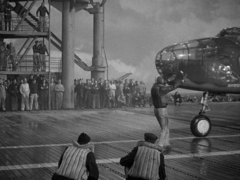 Movie still from “Thirty Seconds Over Tokyo” (1944), directed by Mervyn LeRoy – An airplane on the deck of an aircraft carrier; Wide shot, High angle