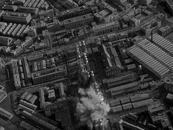 Movie still from “Thirty Seconds Over Tokyo” (1944), directed by Mervyn LeRoy – An aerial view of an industrial area in a city; Extreme Wide shot, High angle