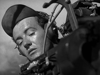 Movie still from “Thirty Seconds Over Tokyo” (1944), directed by Mervyn LeRoy – A man with a helmet on looking at a camera; Close Up shot, Low angle