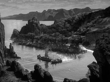 Movie still from “Thirty Seconds Over Tokyo” (1944), directed by Mervyn LeRoy – An old photo of a boat on the water; Extreme Wide shot, High angle