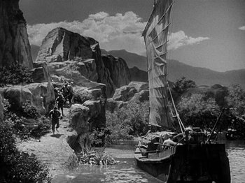 Movie still from “Thirty Seconds Over Tokyo” (1944), directed by Mervyn LeRoy – An old black and white photo of a boat in the water; Extreme Wide shot, High angle