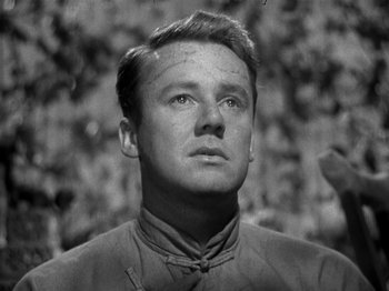 Movie still from “Thirty Seconds Over Tokyo” (1944), directed by Mervyn LeRoy – A man in a black and white photo looking up; Close Up shot, Low angle