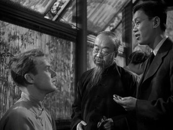 Movie still from “Thirty Seconds Over Tokyo” (1944), directed by Mervyn LeRoy – A group of men standing next to each other; Medium shot, Over the shoulder angle