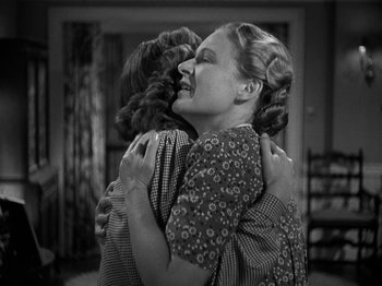 Movie still from “Thirty Seconds Over Tokyo” (1944), directed by Mervyn LeRoy – Two women hugging each other in a living room; Medium shot, High angle