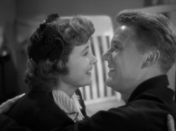 Movie still from “Thirty Seconds Over Tokyo” (1944), directed by Mervyn LeRoy – An older man and a young woman smiling at each other; Close Up shot, High angle