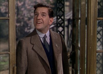 Movie still from “This Happy Breed” (1944), directed by David Lean – A person wearing a suit and tie; Close Up shot, Low angle