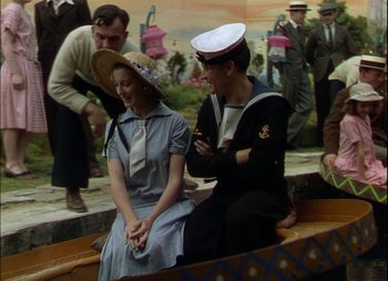Movie still from “This Happy Breed” (1944), directed by David Lean – A man and a woman sitting in a boat; Medium shot, High angle