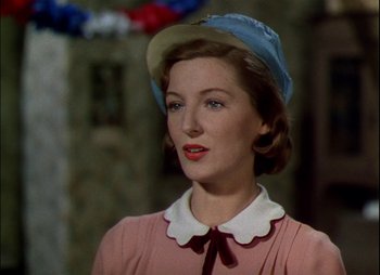 Movie still from “This Happy Breed” (1944), directed by David Lean – A woman wearing a pink dress and a blue hat; Close Up shot, Low angle