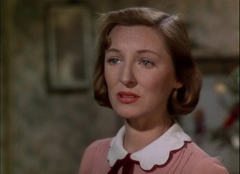 Movie still from “This Happy Breed” (1944), directed by David Lean – A person wearing a pink shirt; Close Up shot, Over the shoulder angle