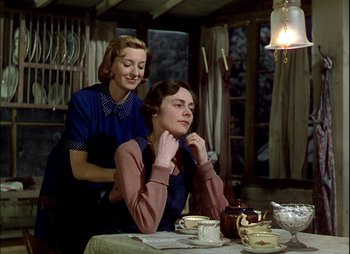Movie still from “This Happy Breed” (1944), directed by David Lean – Two women sitting at a table in a room; Medium shot, Low angle
